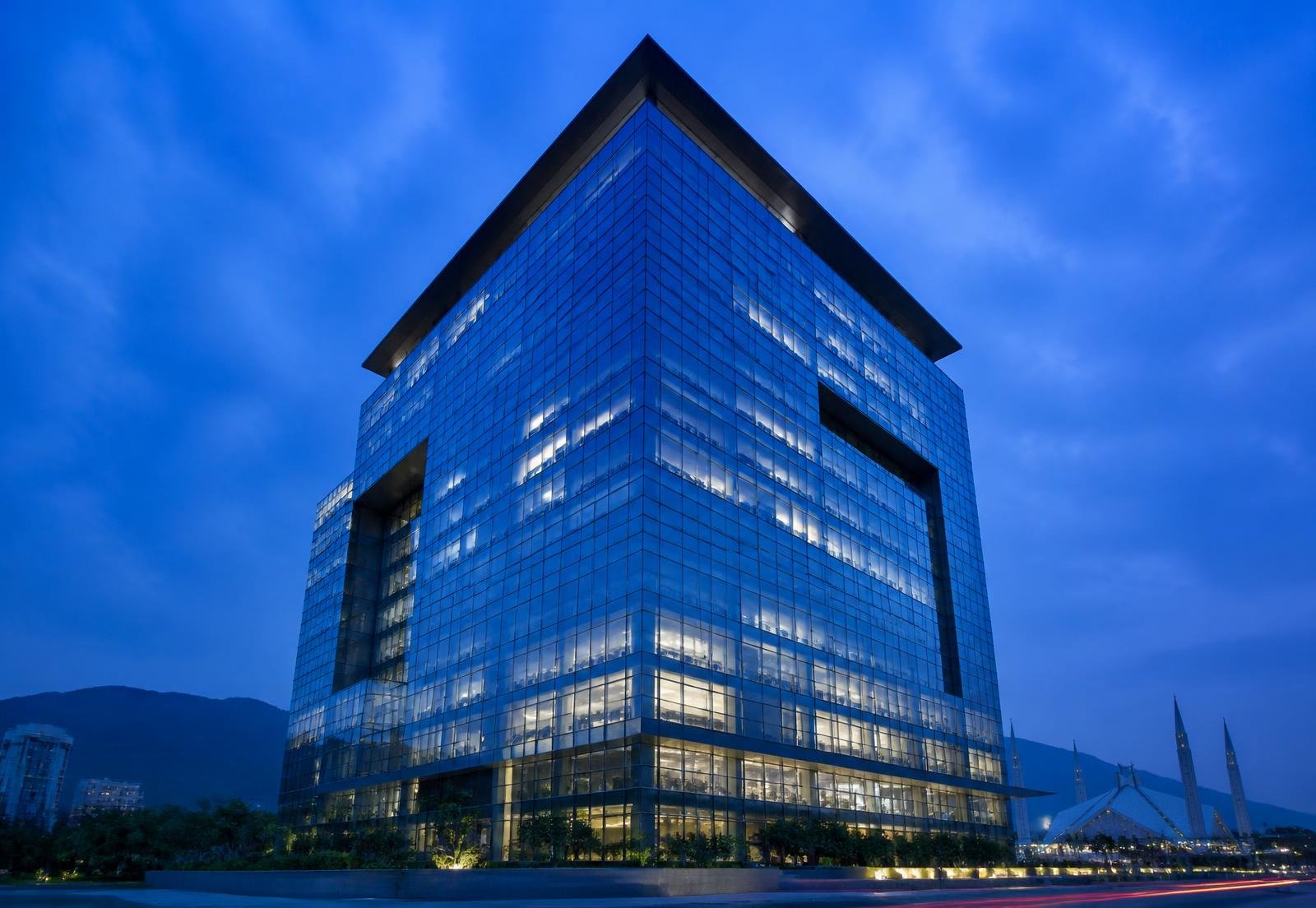 Blue-hour view of a corporate glass tower in Islamabad